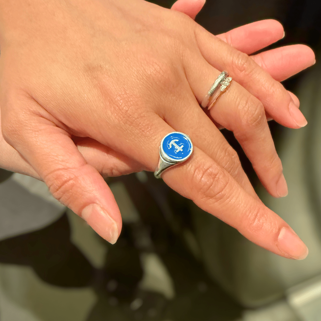 Hand wearing Silver Delta Gamma Anchor Signet Ring, folded over other hand.