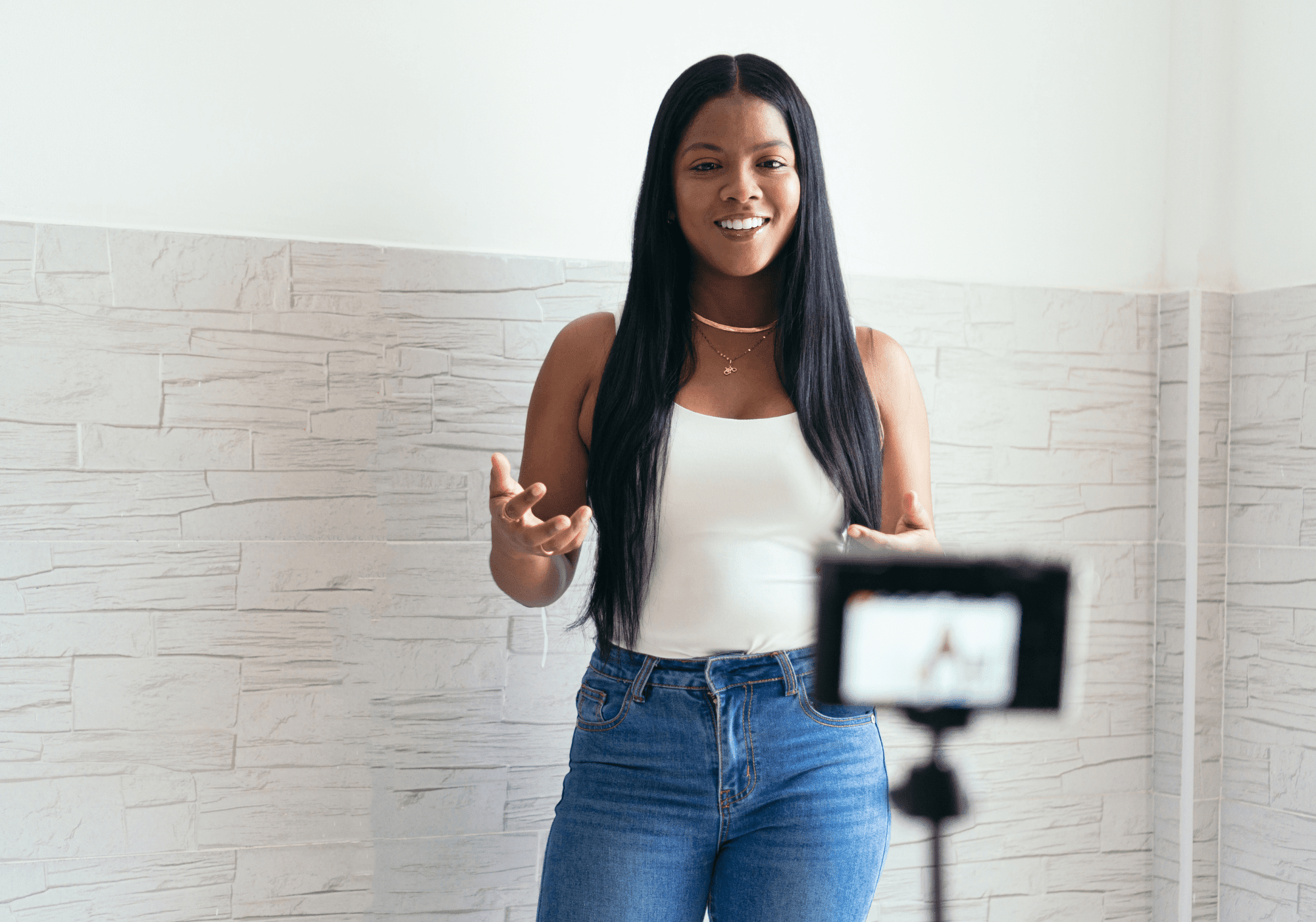 Young woman filming herself talking